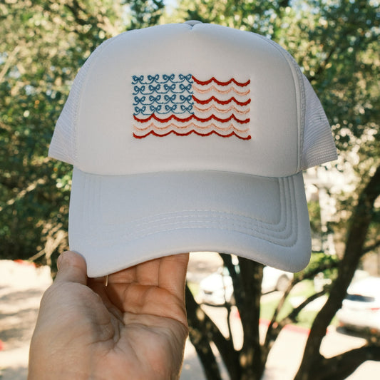 Coquette Bow American Flag embroidered on white trucker hat