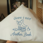 oops i got another book goose on books embroidered on white sweatshirt 