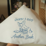 oops i got another book goose on books embroidered on white sweatshirt 